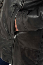 Reddish-brown lambskin coat with quilted warmth and fur-trimmed hood. - Image n°6