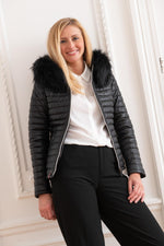 Black sheepskin jacket with glossy quilted look. Racoon fur hood trim. - Image n°6
