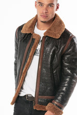 Oiled black sheepskin bomber with cognac shearling lining. - Image n°1
