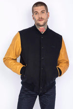 Schott's varsity jacket: navy wool with cognac cowhide sleeves. - Image n°1