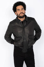 Schott NYC's black goat leather A-2 jacket: a timeless aviator icon. - Image n°1