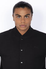 Schott's iconic black varsity jacket blends wool and cowhide leather. - Image n°2