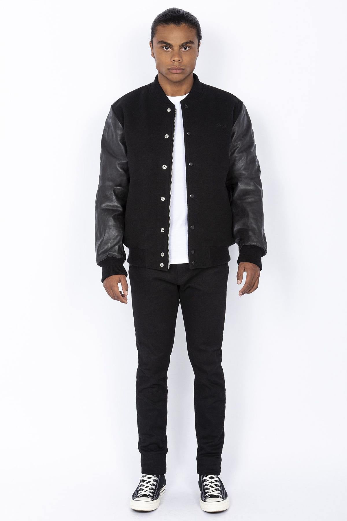 Schott's iconic black varsity jacket blends wool and cowhide leather. - Image n°3