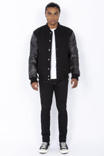Schott's iconic black varsity jacket blends wool and cowhide leather. - Image n°3
