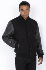 Schott's iconic black varsity jacket blends wool and cowhide leather. - Image n°1