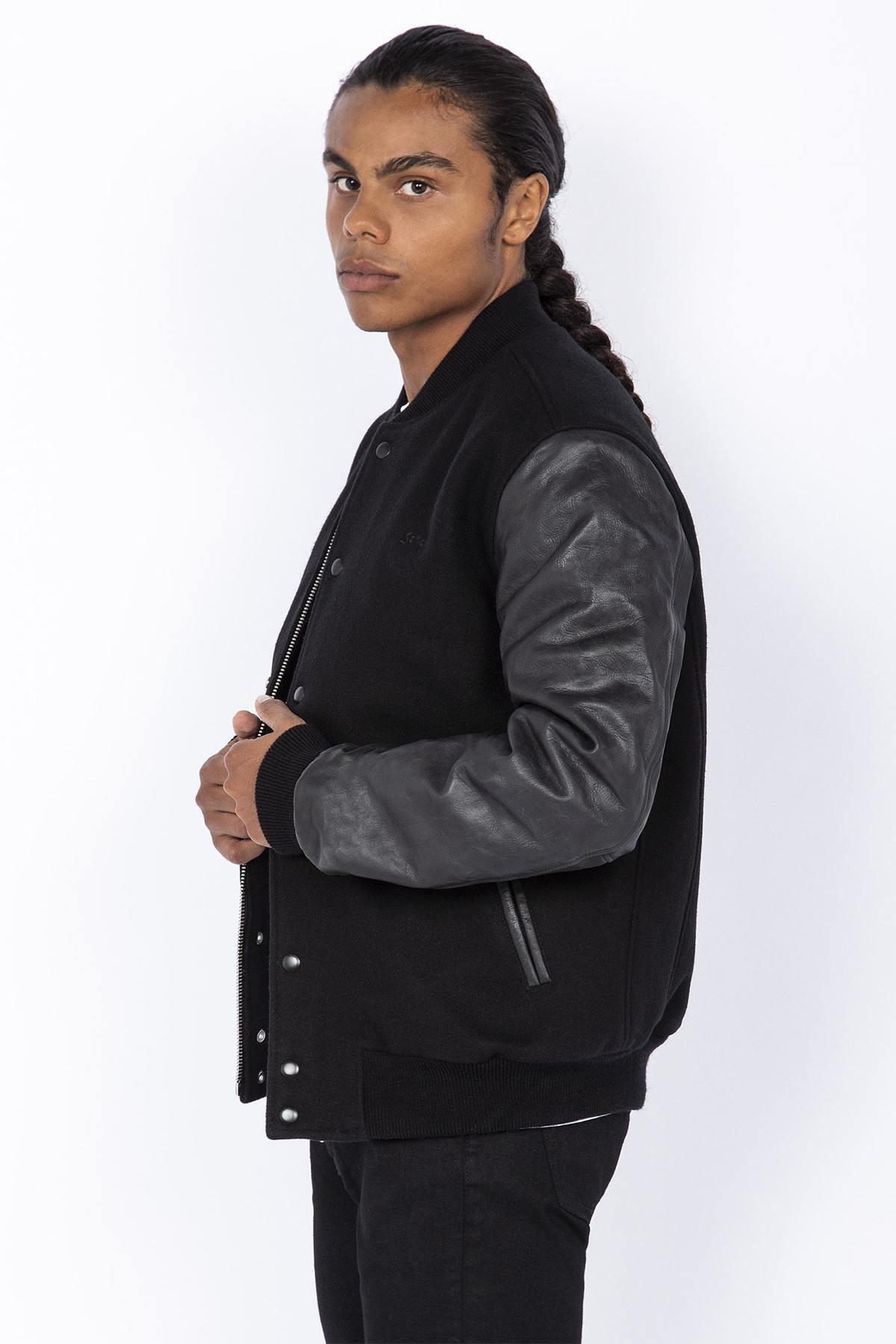Schott's iconic black varsity jacket blends wool and cowhide leather. - Image n°4