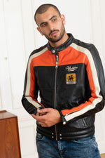 Redskins' black sheepskin jacket with bold orange and white stripes. - Image n°1