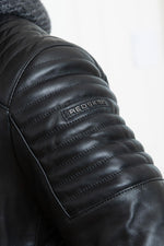 Slim black lambskin jacket with a zip-off wool hood for urban edge. - Image n°9
