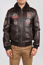 Brown cowhide aviator jacket with vintage patches and epaulettes. - Image n°1