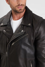 Sleek black cowhide biker jacket with zip sleeves and rivets. - Image n°5