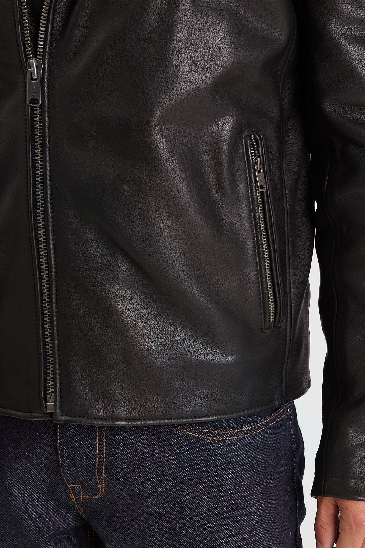 Sleek black cowhide biker jacket with zip sleeves and rivets. - Image n°9