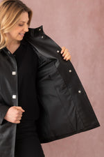 Black lambskin coat, mid-length and glossy, for timeless modern style. - Image n°9