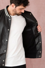 Schott's varsity-style lambskin jacket in black and off-white. - Image n°9