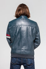 A sleek royal blue sheepskin jacket with sporty contrast stitching. - Image n°6