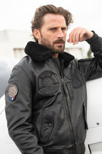 Black sheepskin aviator jacket with fur collar for warmth and style. - Image n°1