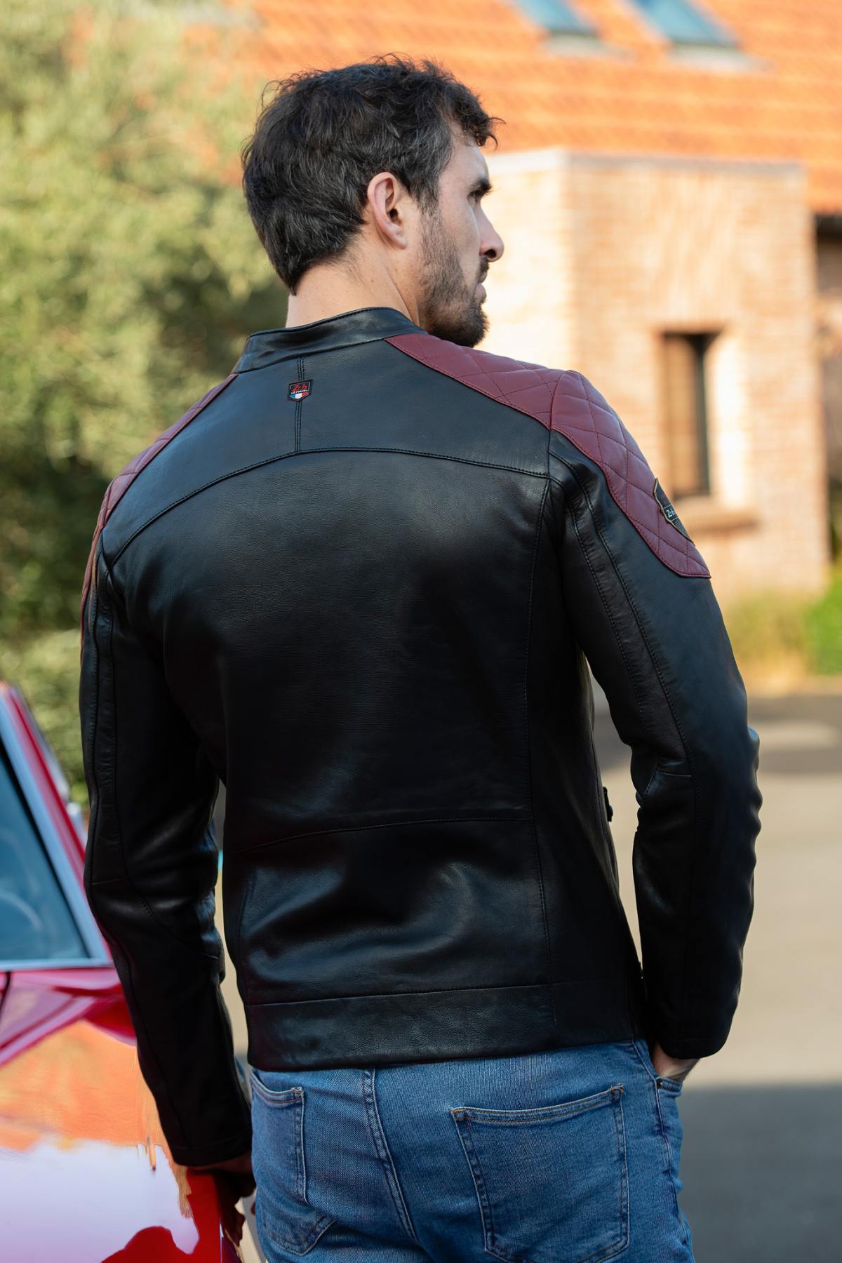Le Mans-inspired black sheep leather jacket with vintage badges. - Image n°4
