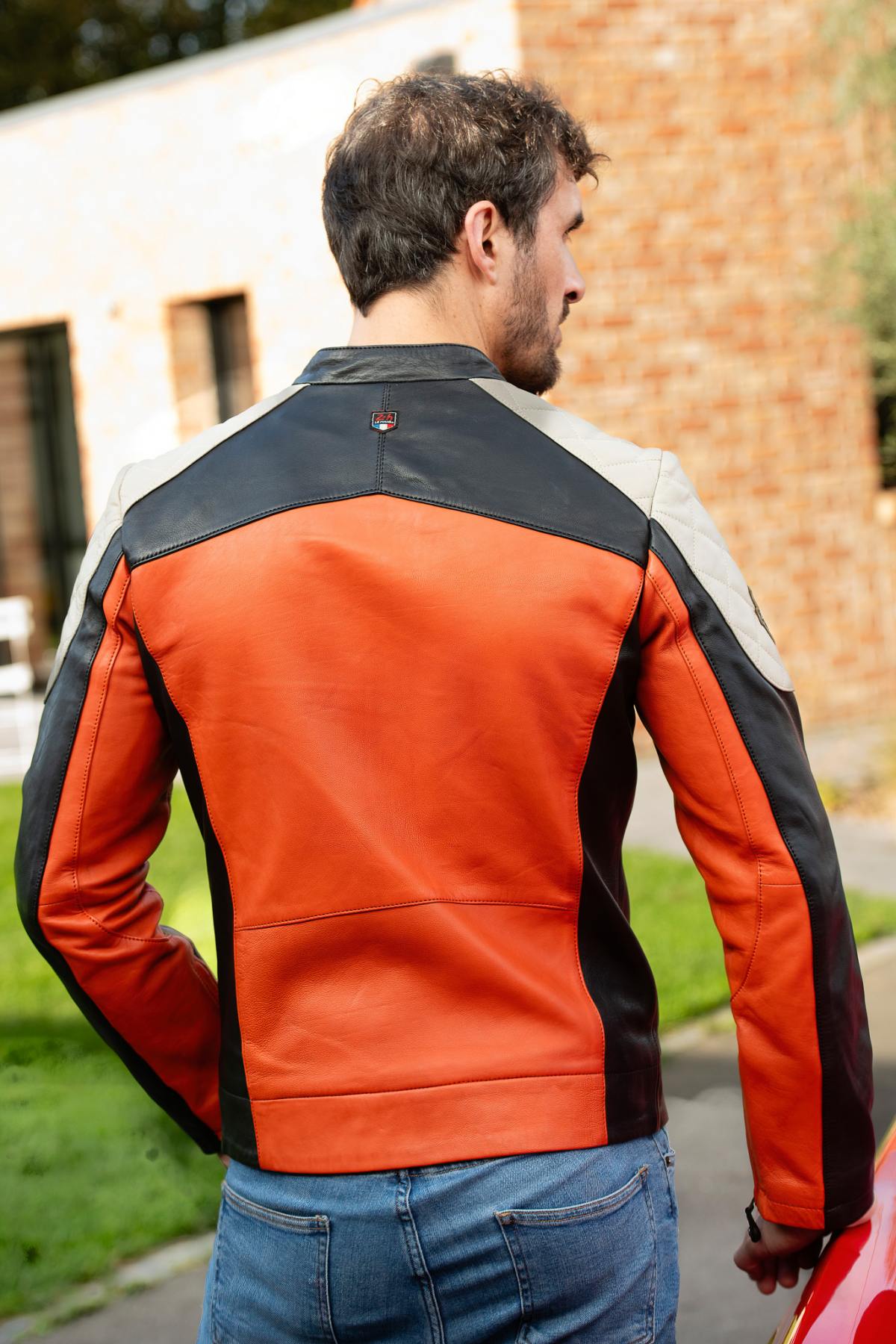 Rider's orange sheepskin jacket. Le Mans heritage, bold biker style. - Image n°3