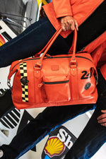 Orange leather travel bag with racing checkerboard - Image n°1