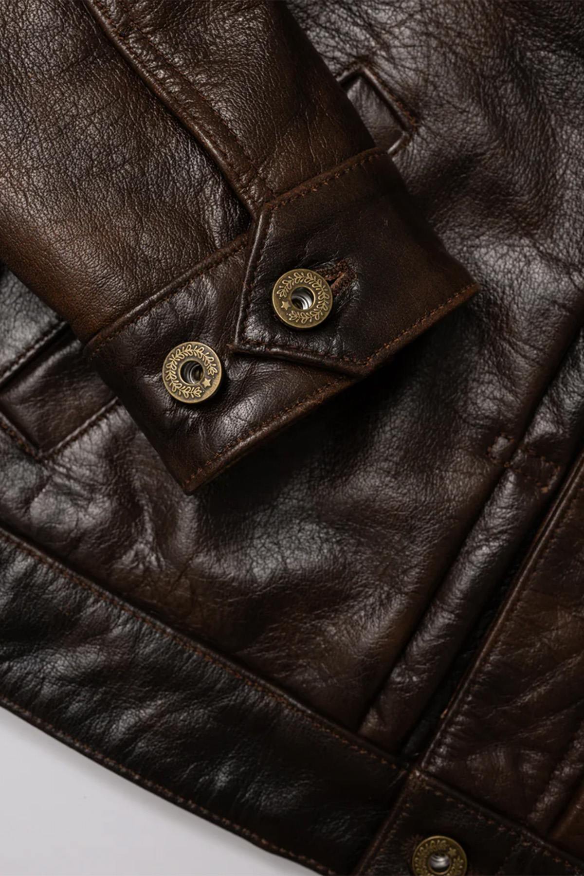 Rustic mahogany buffalo leather trucker jacket with western stitching. - Image n°16
