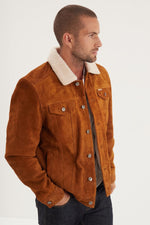 Heavy split cowhide in cognac. Sherpa-lined, slim fit, rugged warmth. - Image n°1