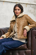 Cosy cognac sheepskin bomber with biker edge for all-season wear. - Image n°1