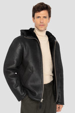 Warm reversed sheepskin bomber by Schott in matte black with a hood. - Image n°1