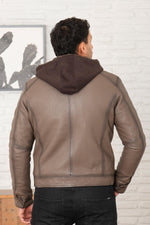 Serge Pariente's taupe lambskin jacket with a removable jersey hood. - Image n°3