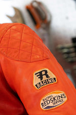 Bold orange lambskin moto jacket with quilted shoulders and patches. - Image n°6