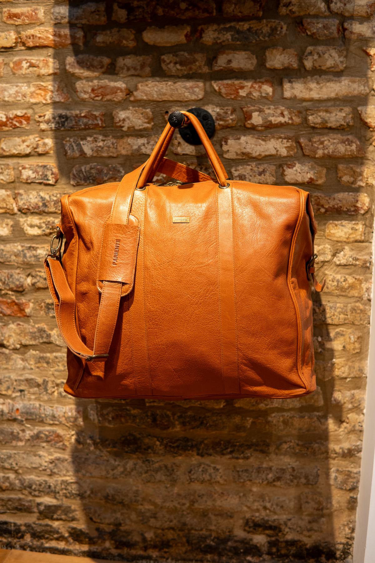 High-end leather travel bag in cognac color. - Image n°1