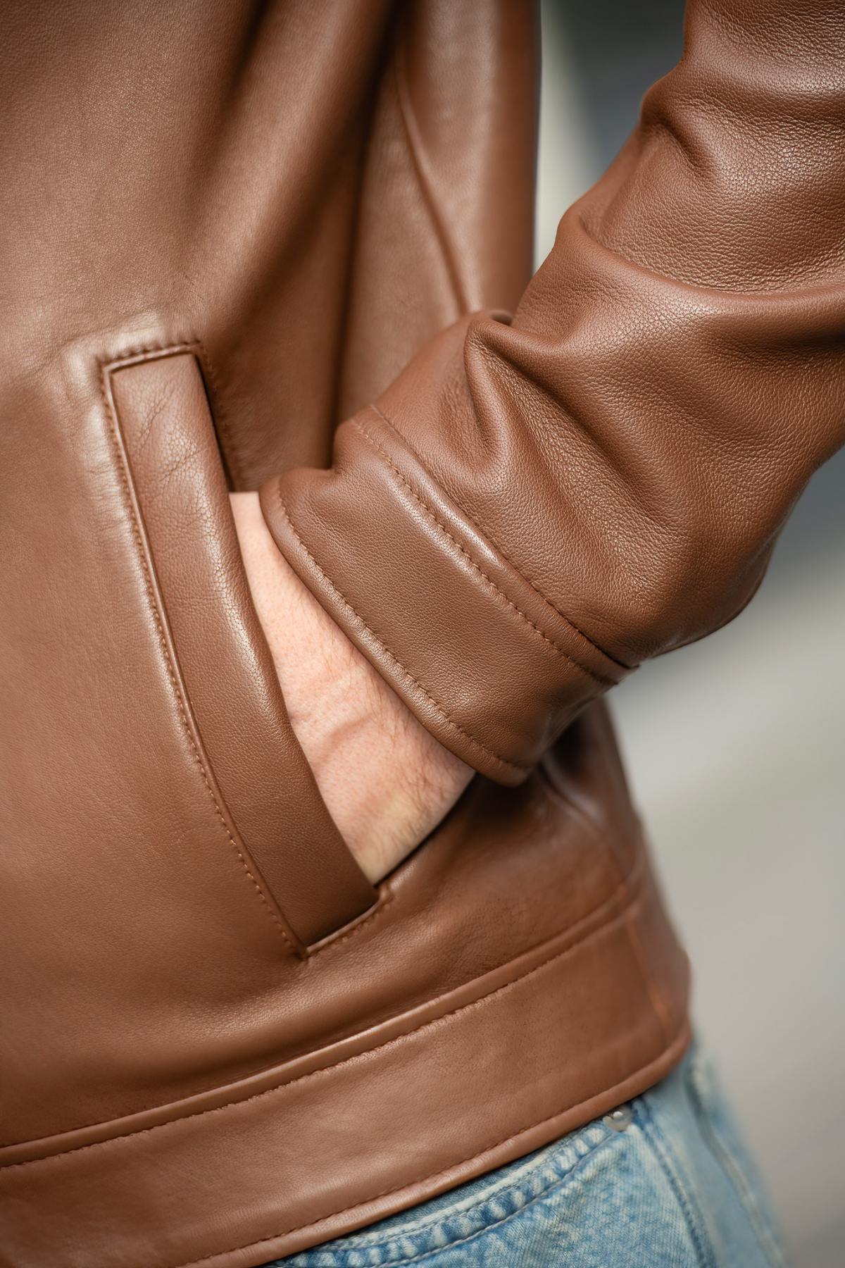 A lambskin jacket in warm cinnamon, a timeless worker style reimagined with sleek sophistication. - Image n°6