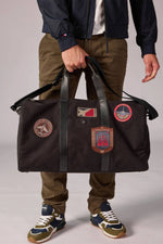 Travel bag in cotton canvas and black leather - Image n°1
