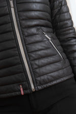 Black sheepskin jacket with glossy quilted look. Racoon fur hood trim. - Image n°8
