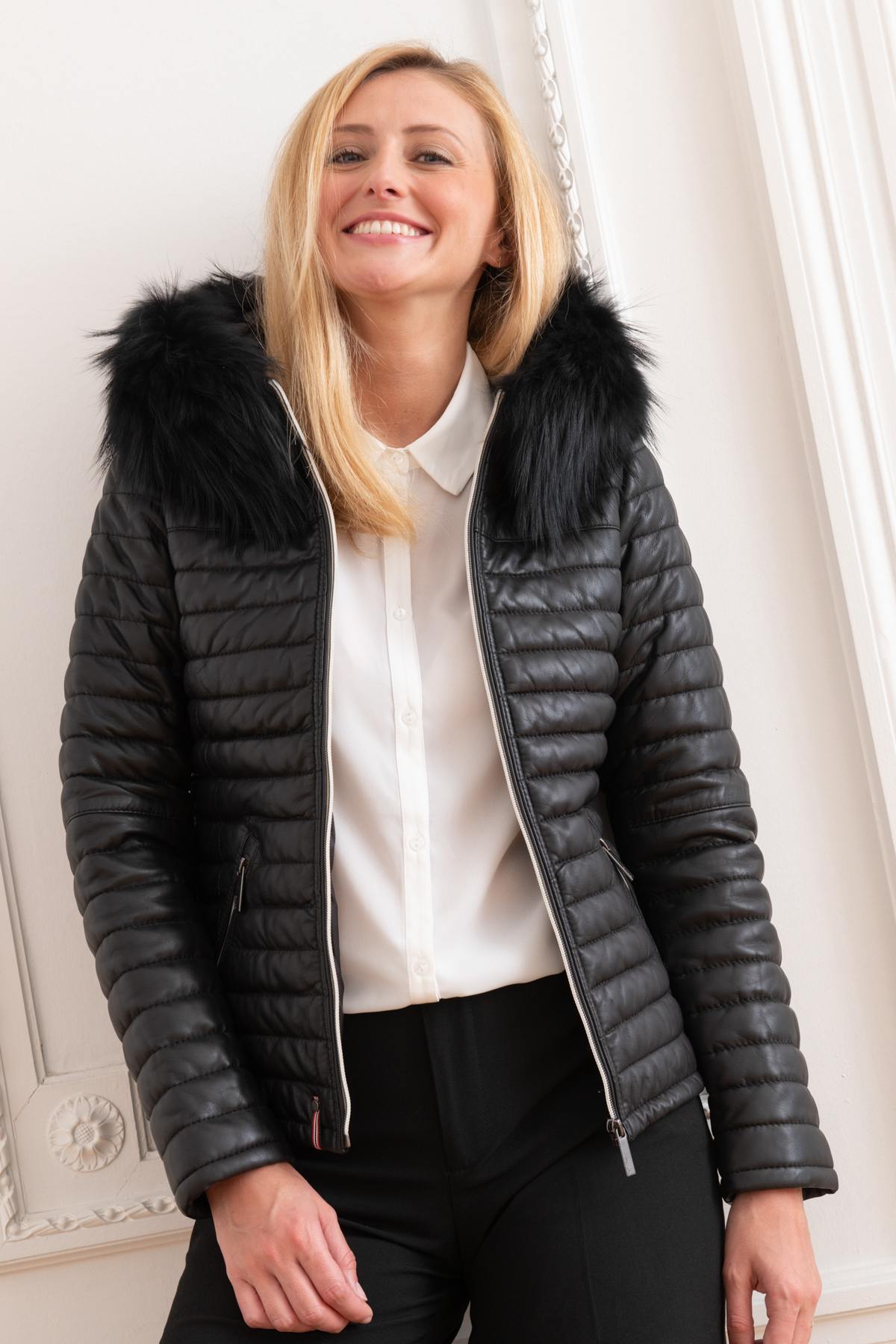 Black sheepskin jacket with glossy quilted look. Racoon fur hood trim. - Image n°1