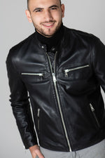 Slim black lambskin jacket with zippered cuffs and burgundy lining. - Image n°1