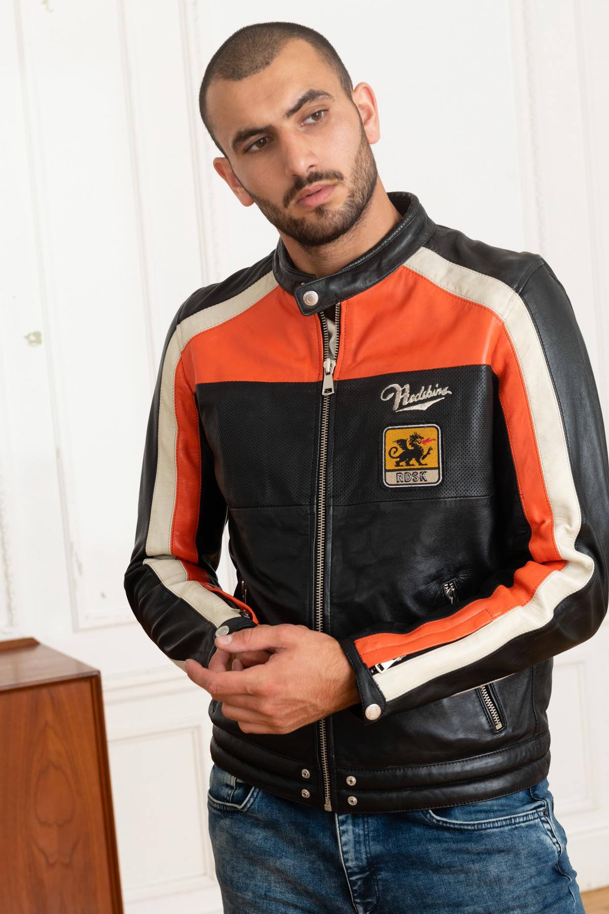Redskins' black sheepskin jacket with bold orange and white stripes. - Image n°1