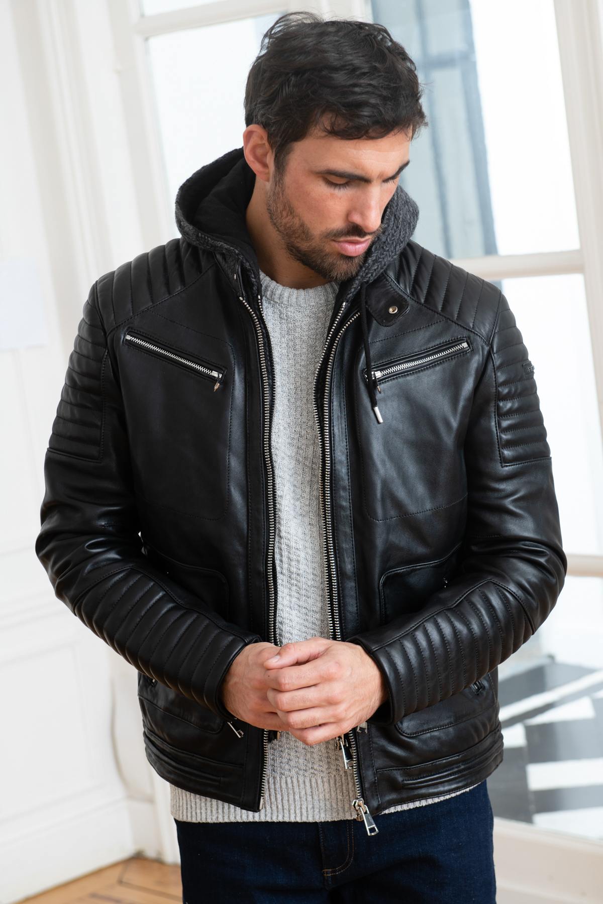 Slim black lambskin jacket with a zip-off wool hood for urban edge. - Image n°1