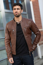 Mid-brown leather jacket with a motard collar and a snug, aged fit. - Image n°1