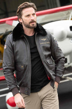 Dark brown sheepskin aviator jacket with RAF insignias and fur collar. - Image n°1