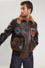 Aviator jacket in tobacco cognac. Fur collar, badge trims, slim fit. - Image n°1