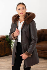 Chocolate lambskin jacket with silky nappa finish and fox-fur hood. - Image n°1