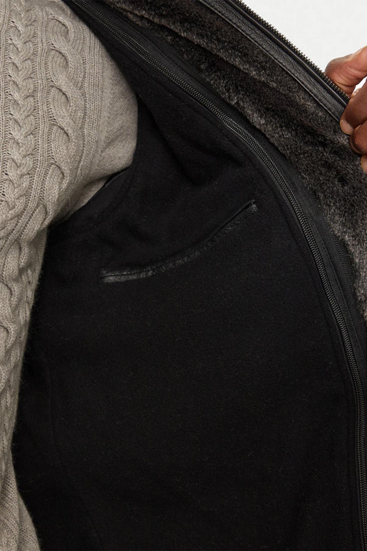Black lambskin parka with detachable vegan-fur hood for urban warmth. - Image n°6