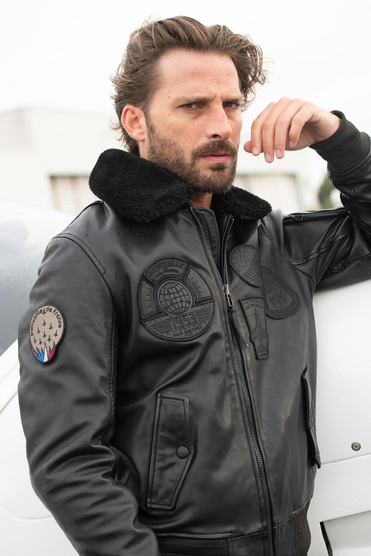 Black sheepskin aviator jacket with fur collar for warmth and style. - Image n°1