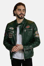 Green leather jacket with textured shoulders and racing badges - Image n°1