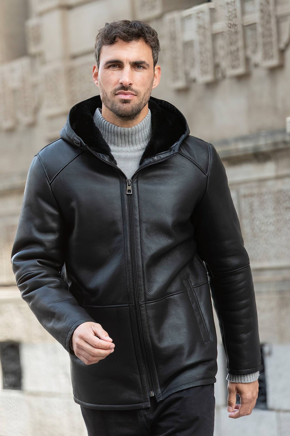 Black hooded long coat in shearling leather - Image n°1