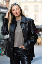 Black buttoned leather jacket with a clean-cut look - Image n°1